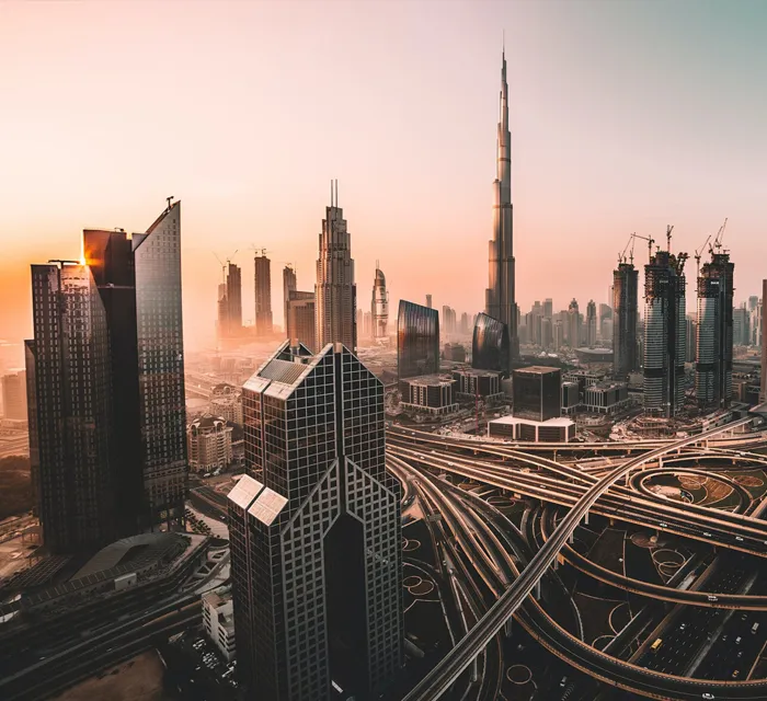 Business professionals planning a new venture in a modern Dubai office with Burj Khalifa in the background